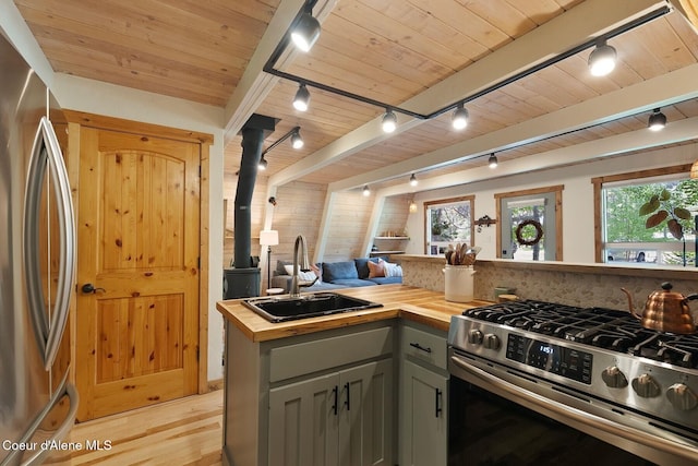 11 Hackney Ln, Sandpoint, ID 83864 - kitchen featuring butcher block countertops, stainless steel appliances, track lighting, a sink, and light wood finished floors