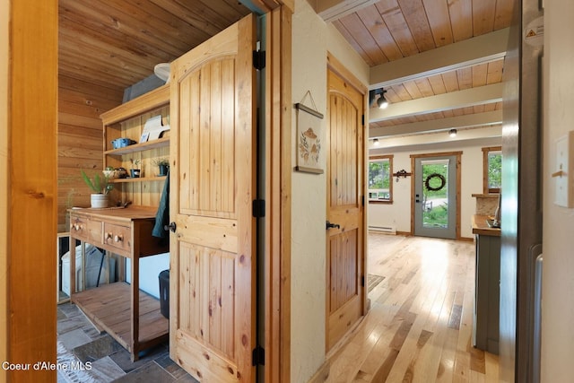11 Hackney Ln, Sandpoint, ID 83864 - corridor with wooden ceiling, a baseboard radiator, light wood-type flooring, and wood walls