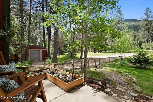 11 Hackney Ln, Sandpoint, ID 83864 - view of yard featuring an outbuilding and a wooded view
