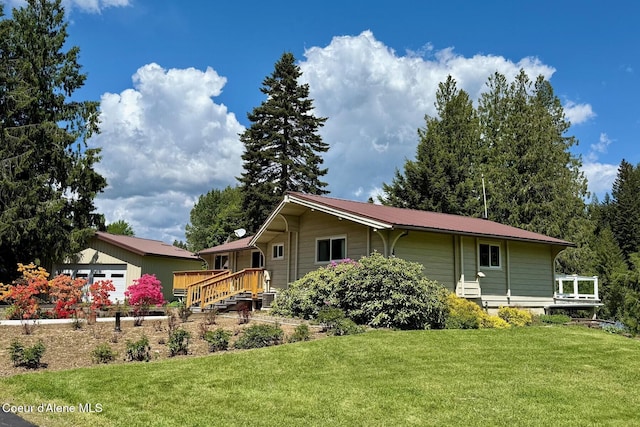 659 Whiskey Jack Rd, Sandpoint, ID 83864 - back of property with a yard, metal roof, and a garage