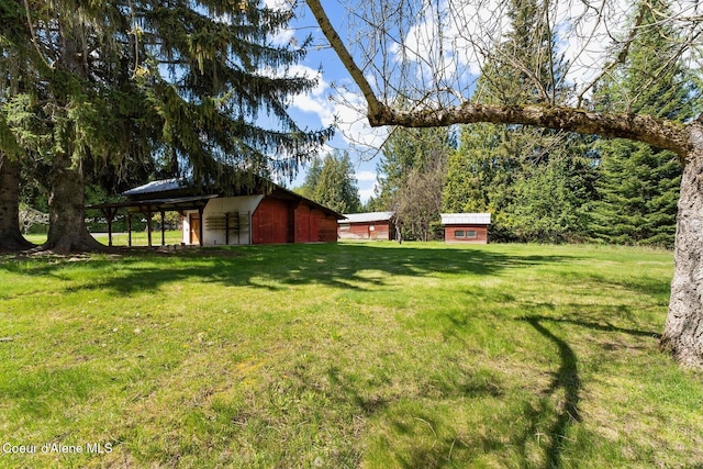 659 Whiskey Jack Rd, Sandpoint, ID 83864 - view of grassy yard featuring an outbuilding and a pole building