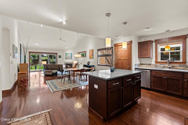 305 Maddie Ln, Sandpoint, ID 83864 - kitchen with stainless steel dishwasher, a sink, a kitchen island, dark wood-style floors, and pendant lighting