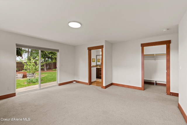 305 Maddie Ln, Sandpoint, ID 83864 - unfurnished bedroom featuring access to outside, baseboards, light carpet, and a spacious closet
