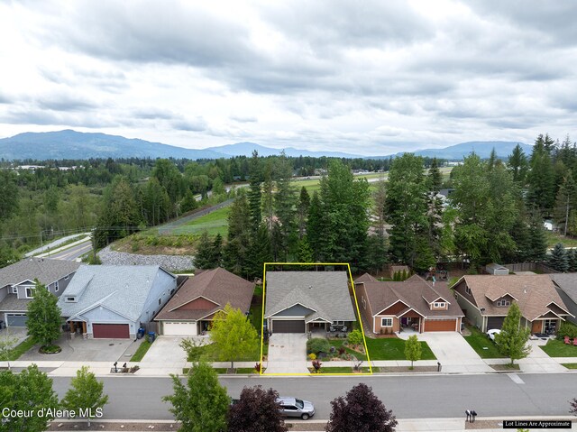 305 Maddie Ln, Sandpoint, ID 83864 - aerial perspective of suburban area featuring mountains and property parcel outlined