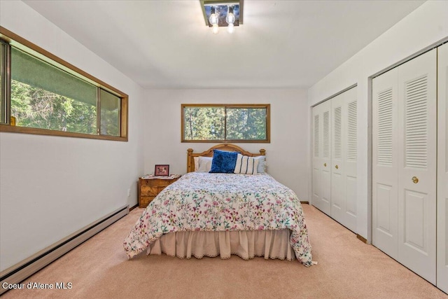 12696 N Dover Ln, Hayden, ID 83835 - bedroom featuring a baseboard heating unit, carpet flooring, and multiple closets