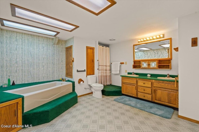 12696 N Dover Ln, Hayden, ID 83835 - bathroom with a garden tub, double vanity, toilet, and baseboards