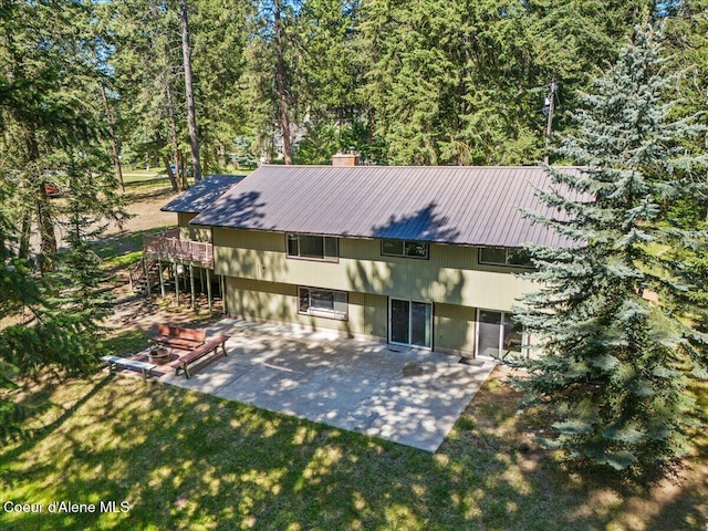 12696 N Dover Ln, Hayden, ID 83835 - back of house featuring a patio area, a chimney, stairway, metal roof, and a wooden deck