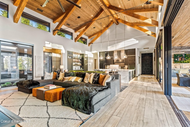 6361 S Cormorant Ct, Harrison, ID 83833 - living room with high vaulted ceiling, wood ceiling with exposed beams, and light wood finished floors