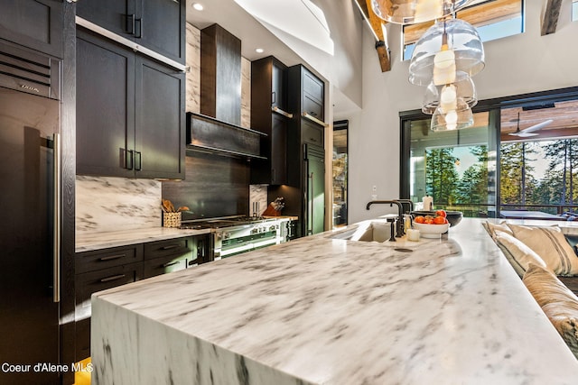 6361 S Cormorant Ct, Harrison, ID 83833 - kitchen with fridge, a sink, decorative backsplash, light stone countertops, and a towering ceiling