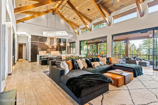 6361 S Cormorant Ct, Harrison, ID 83833 - living room with high vaulted ceiling, light wood-style floors, and wooden ceiling with exposed beams