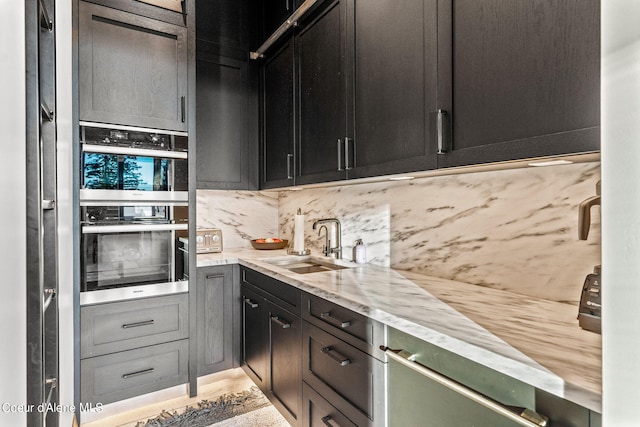6361 S Cormorant Ct, Harrison, ID 83833 - kitchen with a sink, stainless steel double oven, decorative backsplash, and light stone countertops