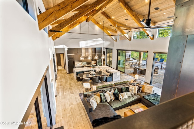 6361 S Cormorant Ct, Harrison, ID 83833 - sunken living room with high vaulted ceiling, wood ceiling with exposed beams, light wood-style flooring, and a ceiling fan
