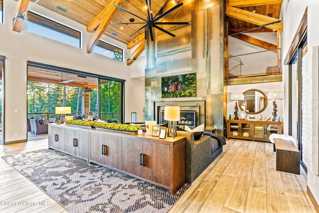 6361 S Cormorant Ct, Harrison, ID 83833 - living area with a towering ceiling, wood-type flooring, wood ceiling with exposed beams, and a fireplace