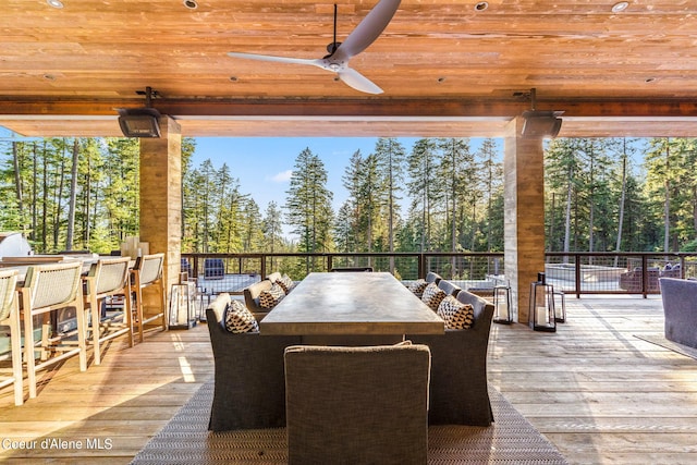 6361 S Cormorant Ct, Harrison, ID 83833 - deck with a ceiling fan, view of wooded area, and outdoor dining space