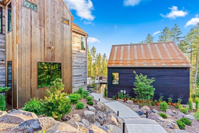 6361 S Cormorant Ct, Harrison, ID 83833 - view of home's exterior featuring metal roof, an outdoor structure, and a standing seam roof