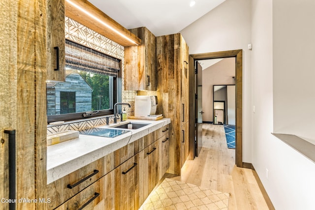 6361 S Cormorant Ct, Harrison, ID 83833 - kitchen featuring a sink, light wood-style floors, light countertops, tasteful backsplash, and baseboards