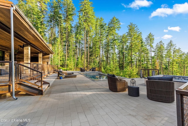 6361 S Cormorant Ct, Harrison, ID 83833 - view of patio / terrace with an outdoor pool and a view of trees