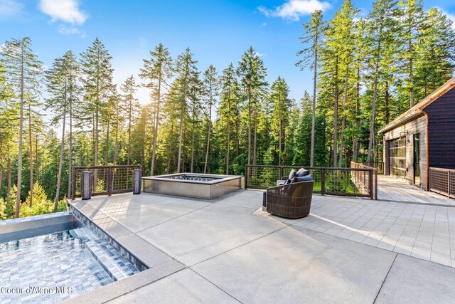 6361 S Cormorant Ct, Harrison, ID 83833 - view of patio / terrace featuring a wooden deck, a hot tub, and a view of trees