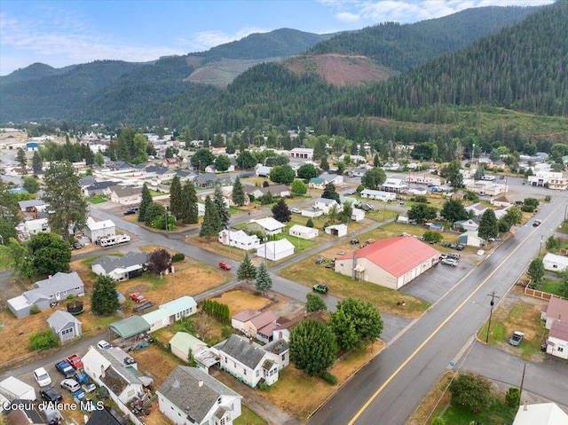 301 Third St, Osburn, ID 83849 - aerial view of residential area featuring a forest and mountains