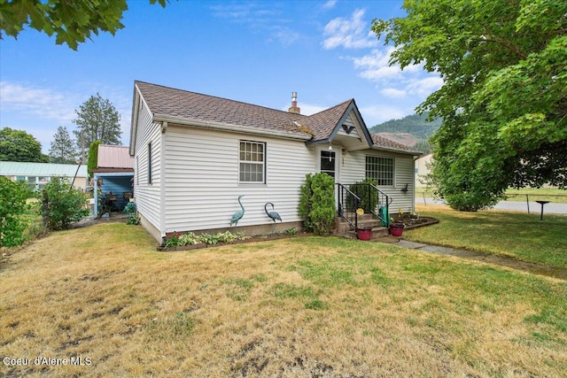 301 Third St, Osburn, ID 83849 - view of front of home with a chimney and a shingled roof