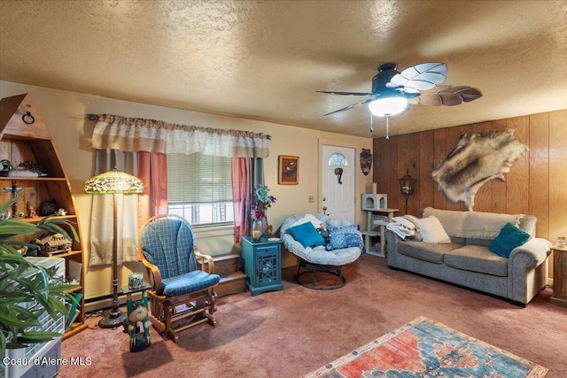 301 Third St, Osburn, ID 83849 - carpeted living area featuring a textured ceiling, a ceiling fan, and wood walls