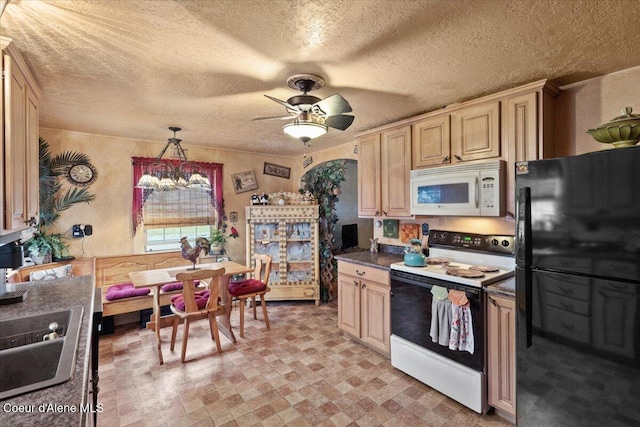 301 Third St, Osburn, ID 83849 - kitchen with white microwave, freestanding refrigerator, electric stove, ceiling fan, and dark countertops