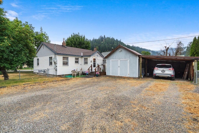 301 Third St, Osburn, ID 83849 - ranch-style house with a chimney, driveway, and entry steps