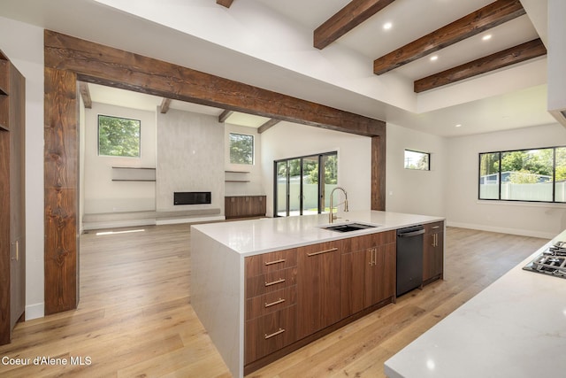1456 E Ezra Ave, Hayden, ID 83835 - kitchen featuring a sink, open floor plan, beamed ceiling, a large island with sink, and modern cabinets