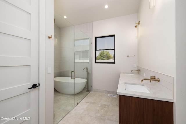 1456 E Ezra Ave, Hayden, ID 83835 - bathroom with a freestanding tub, double vanity, recessed lighting, and a stall shower