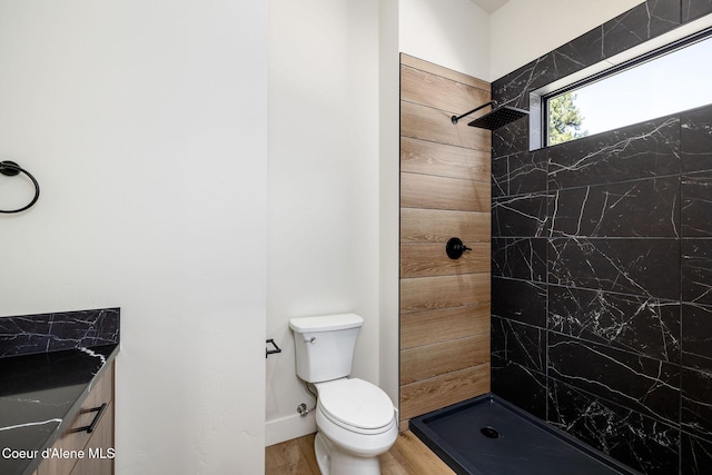 1456 E Ezra Ave, Hayden, ID 83835 - bathroom featuring toilet, a tile shower, wood finished floors, and vanity