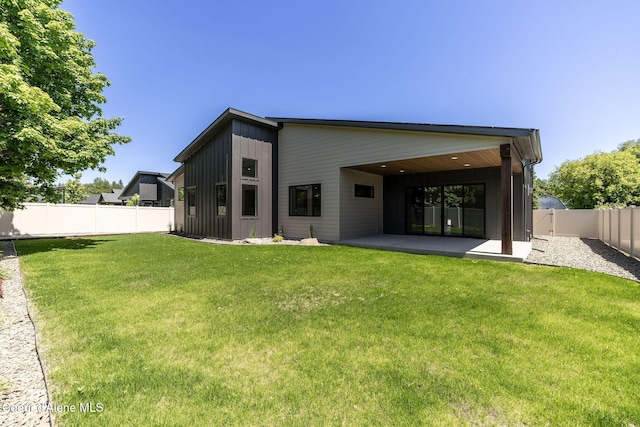 1456 E Ezra Ave, Hayden, ID 83835 - rear view of house featuring a patio area and board and batten siding