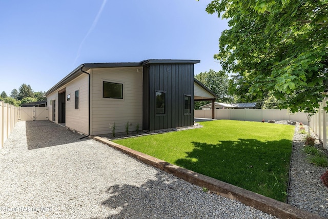 1456 E Ezra Ave, Hayden, ID 83835 - back of house with board and batten siding and a gate
