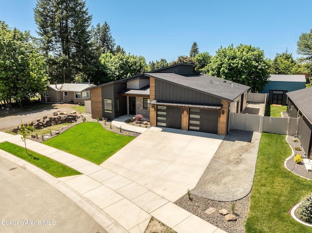 1456 E Ezra Ave, Hayden, ID 83835 - view of front facade with a garage, concrete driveway, board and batten siding, roof with shingles, and a gate