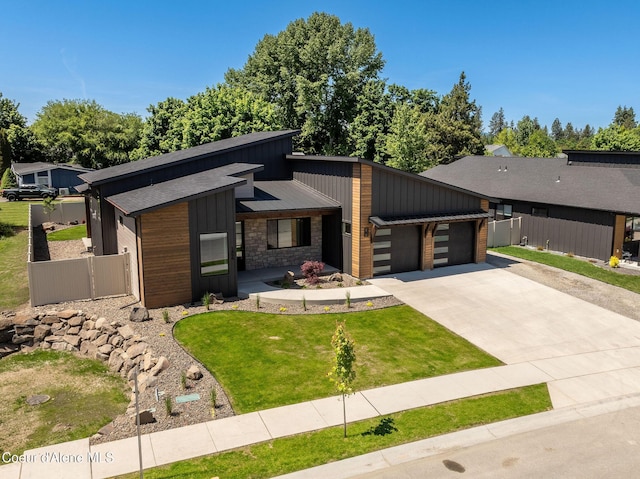 1456 E Ezra Ave, Hayden, ID 83835 - view of front of property with an attached garage, driveway, board and batten siding, and stone siding