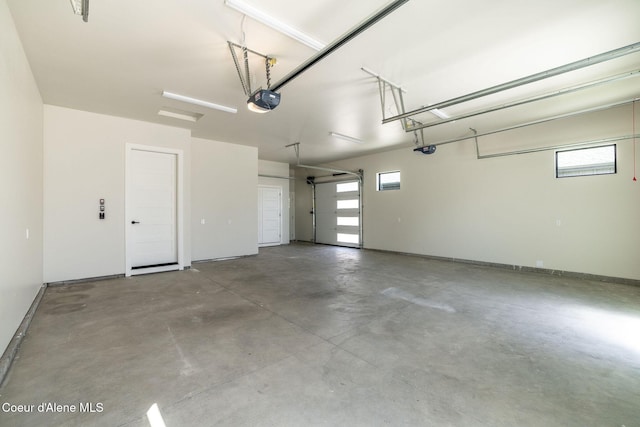 1456 E Ezra Ave, Hayden, ID 83835 - garage with a garage door opener and baseboards