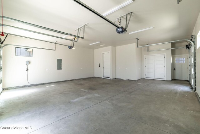 1456 E Ezra Ave, Hayden, ID 83835 - garage featuring electric panel and a garage door opener