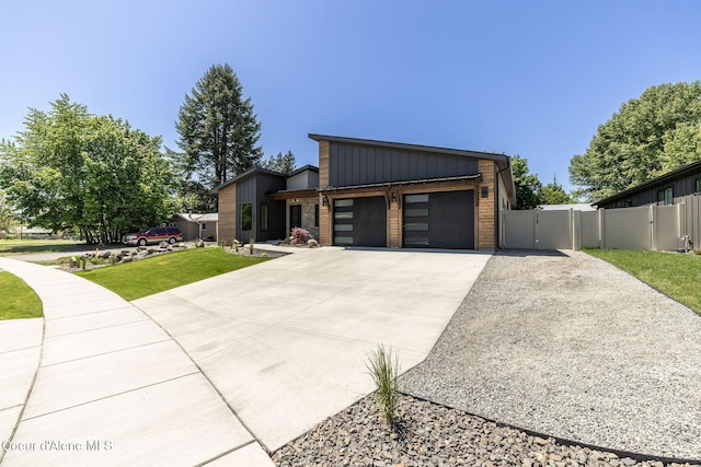 1456 E Ezra Ave, Hayden, ID 83835 - modern home featuring a gate, concrete driveway, a garage, and brick siding