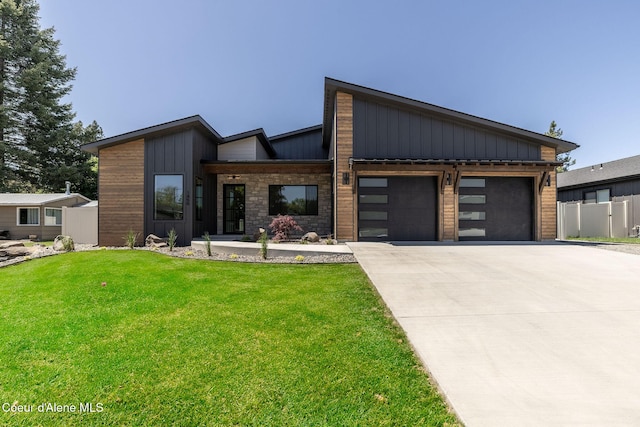 1456 E Ezra Ave, Hayden, ID 83835 - contemporary house with board and batten siding, a garage, and driveway