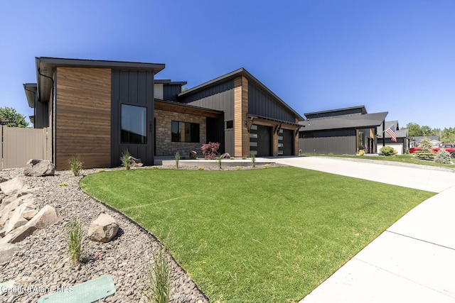 1456 E Ezra Ave, Hayden, ID 83835 - contemporary house featuring an attached garage, driveway, and stone siding