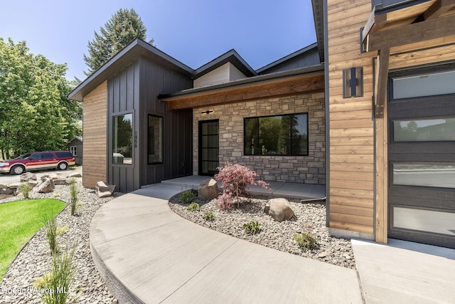 1456 E Ezra Ave, Hayden, ID 83835 - doorway to property with board and batten siding, stone siding, and covered porch