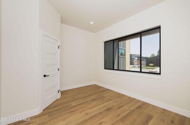 1456 E Ezra Ave, Hayden, ID 83835 - empty room with baseboards, light wood finished floors, and recessed lighting