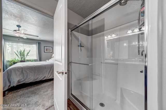 7156 W Christine St, Rathdrum, ID 83858 - ensuite bathroom featuring a textured ceiling, a stall shower, and a ceiling fan