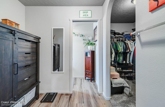 7156 W Christine St, Rathdrum, ID 83858 - walk in closet with light wood finished floors and arched walkways