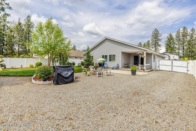 7156 W Christine St, Rathdrum, ID 83858 - back of house with a gate and a patio
