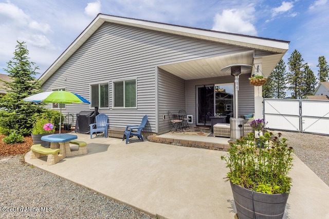 7156 W Christine St, Rathdrum, ID 83858 - rear view of house featuring a patio area and a gate