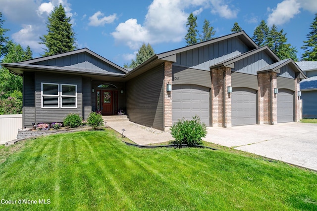 3061 E Lake Forest Dr, Hayden Lake, ID 83835 - view of front of property with a garage, a front lawn, driveway, board and batten siding, and brick siding