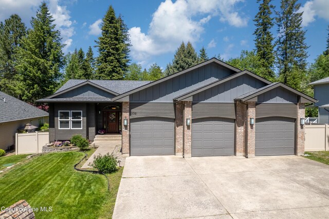 3061 E Lake Forest Dr, Hayden Lake, ID 83835 - view of front of property with a garage, driveway, brick siding, board and batten siding, and a shingled roof