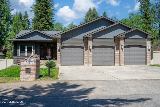 3061 E Lake Forest Dr, Hayden Lake, ID 83835 - view of front of home featuring an attached garage, driveway, and brick siding