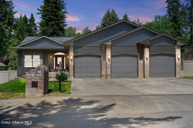 3061 E Lake Forest Dr, Hayden Lake, ID 83835 - view of front of home with a garage, concrete driveway, and brick siding