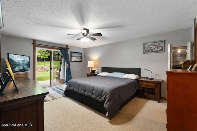 272 Hidden Springs Rd, Sandpoint, ID 83864 - bedroom featuring access to exterior, light carpet, a textured ceiling, and a ceiling fan